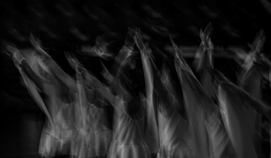 Black and white image capturing dancers in motion
