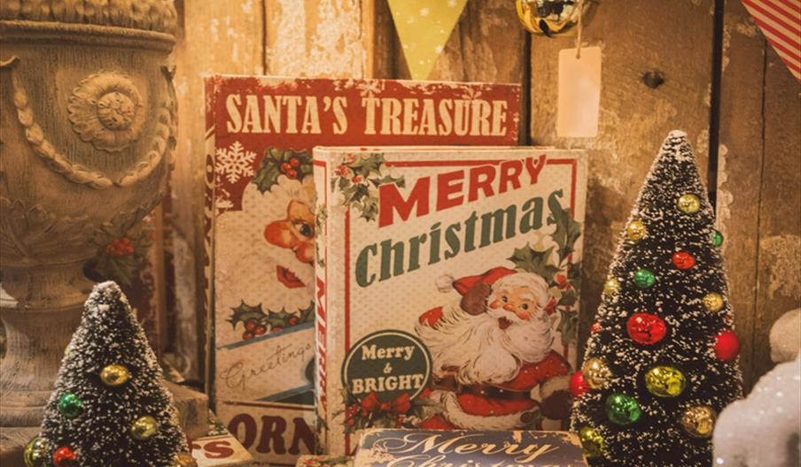 Books with Santa on the front and two tiny Christmas trees