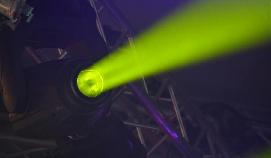 Close-up of green spotlight and stage-lighting rig
