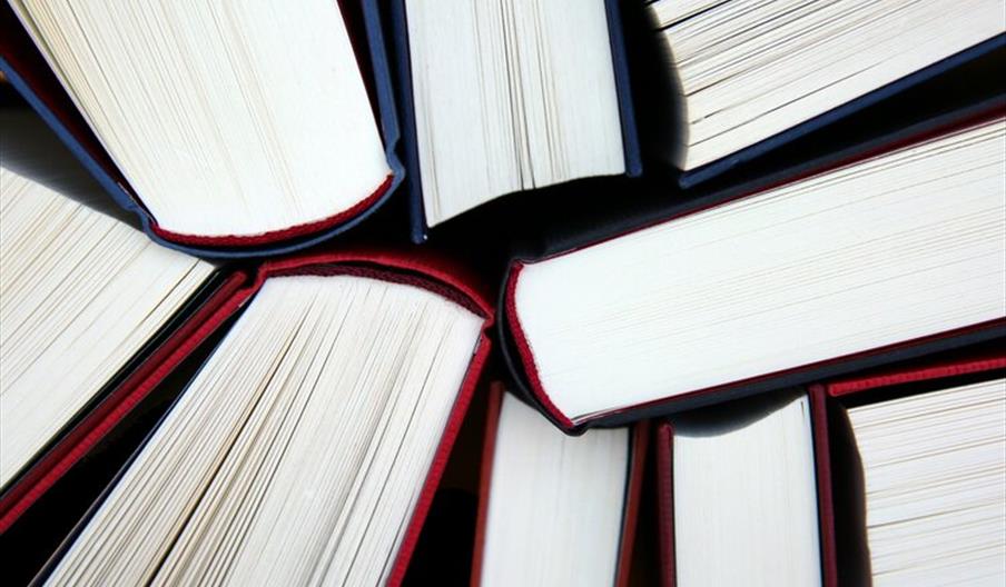 Nine book spines in a cluster from top