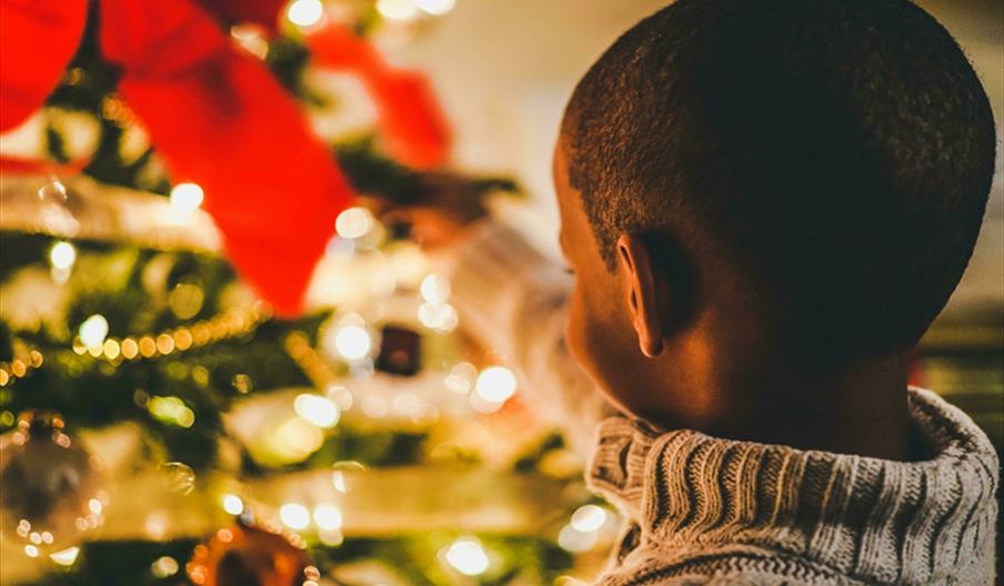 Small child close to Christmas tree