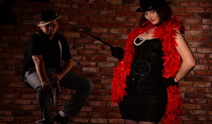 Man and woman in cabaret outfits