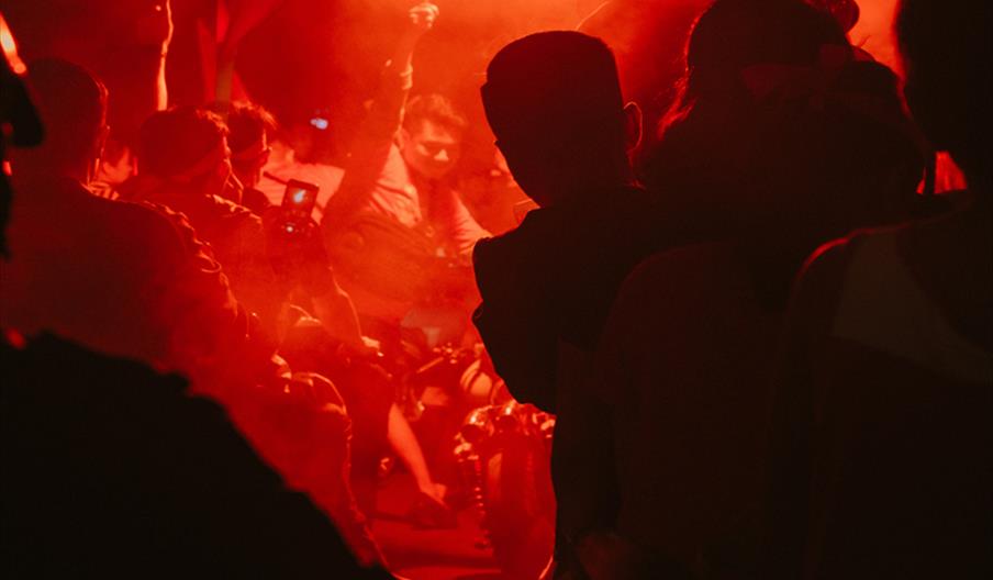 Dancers in orange lit night club