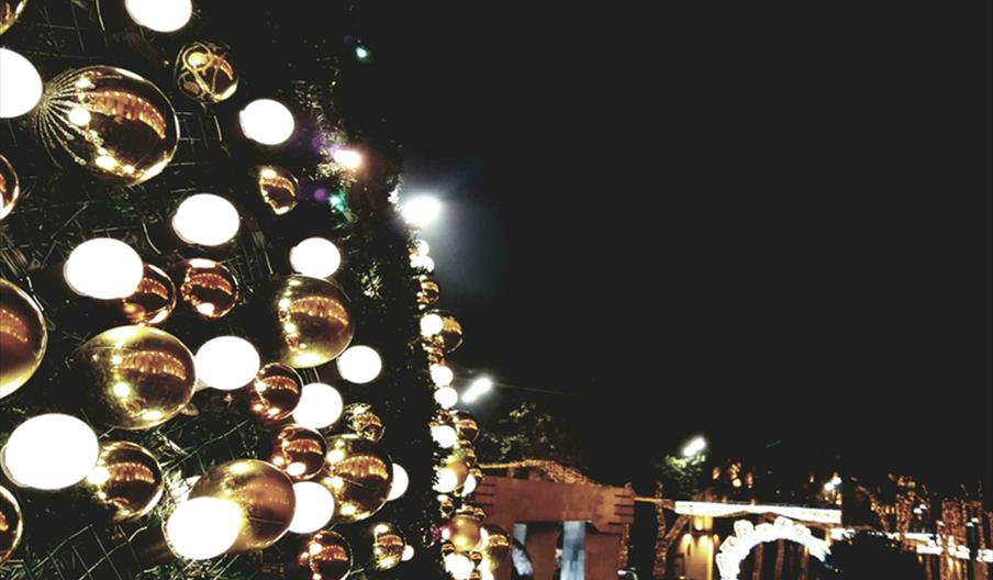 Gold and silver baubles displayed on the wall of an outdoor display