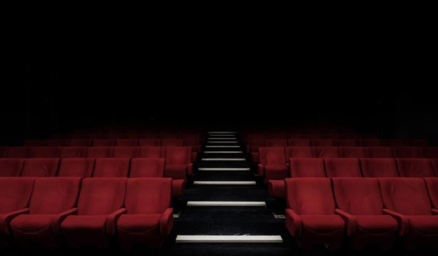 Empty red seats in a theatre